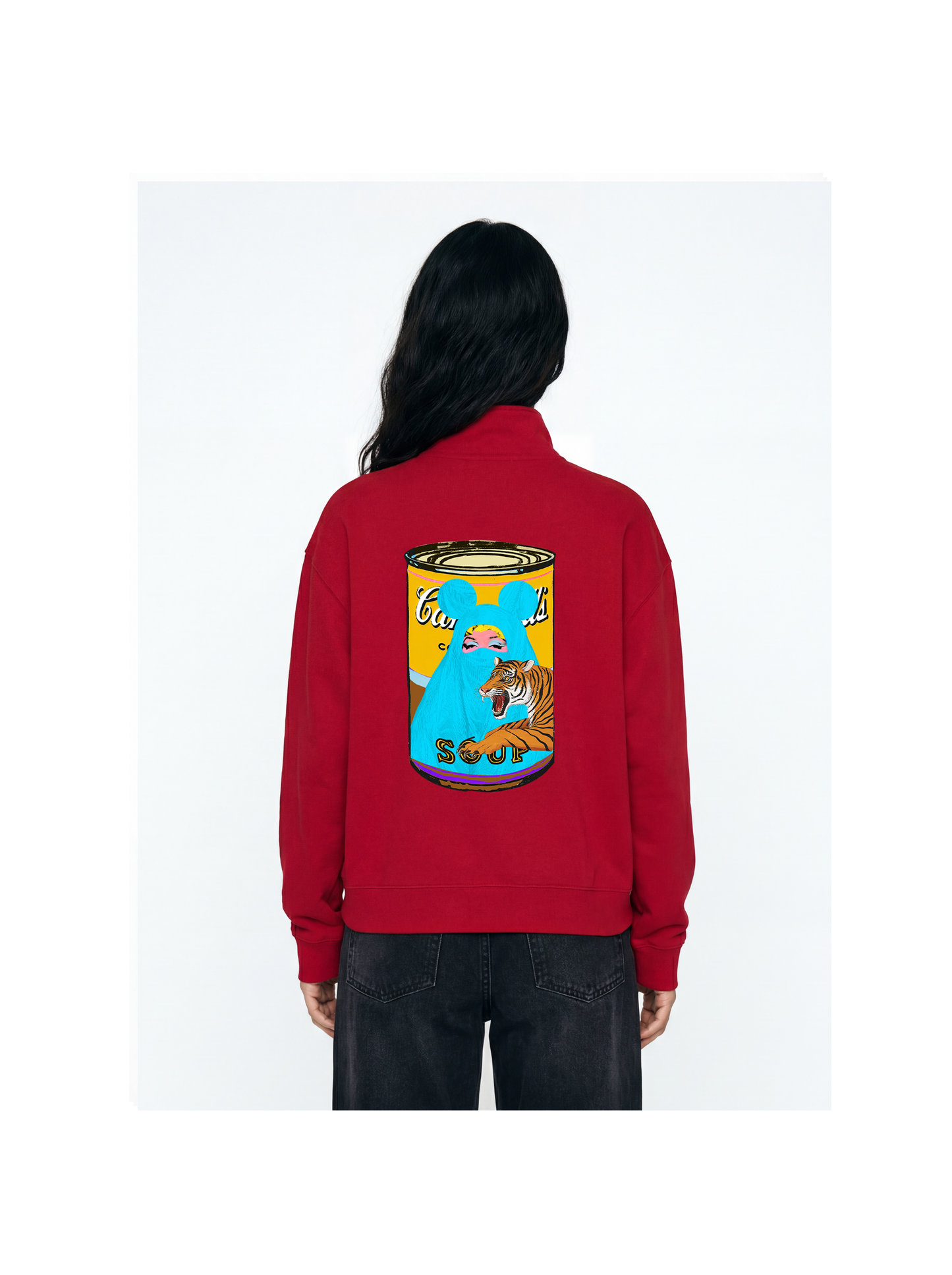 Red sweatshirt with a graphic design on the back worn by a person against a white background